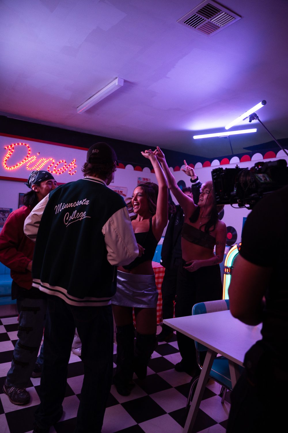 Dancing in a retro diner under purple light