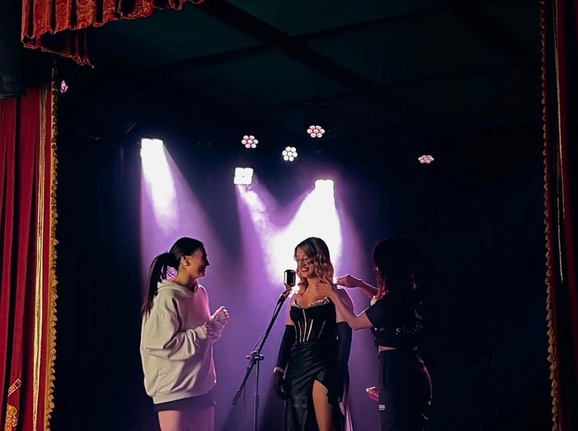 Preparing a singer at a vintage microphone on stage