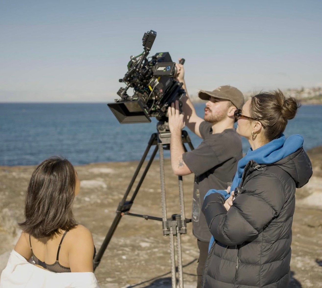 Directing beside a cinema camera by the ocean